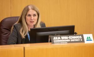 Commissioner Julia Brim-Edwards speaks on the dias