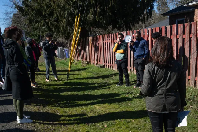 “I always dreamed of having a sidewalk so I wouldn’t get my shoes dirty,” Ahemed Bullo said at a stop between Northeast Alberta and Killingsworth Streets, down the street from Kʰunamokwst Park.