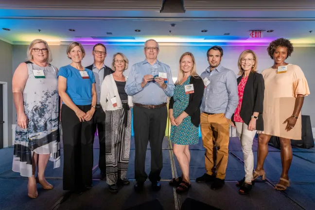 Project Manager JD Deschamps (center) poses with members of the courthouse project team, Portland Business Journal staff and other Transformer Award awardees.
