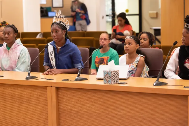 Four participants with the Mr. and Miss Juneteenth Program and Pageant spoke with the Board. Princess Fletcher (second from left) who was crowned Ms. Juneteenth Oregon 2023, recited an original poem.