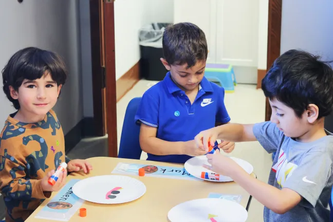 Preschoolers at IRCO sit at a table together.