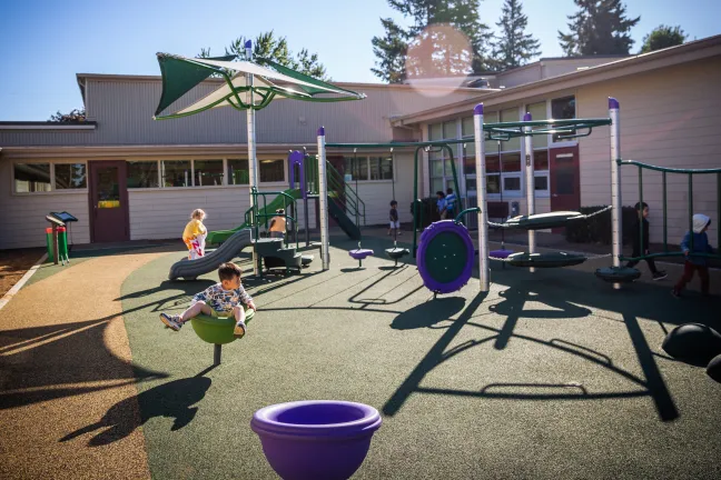 Children on Menlo Park playground with sun shining